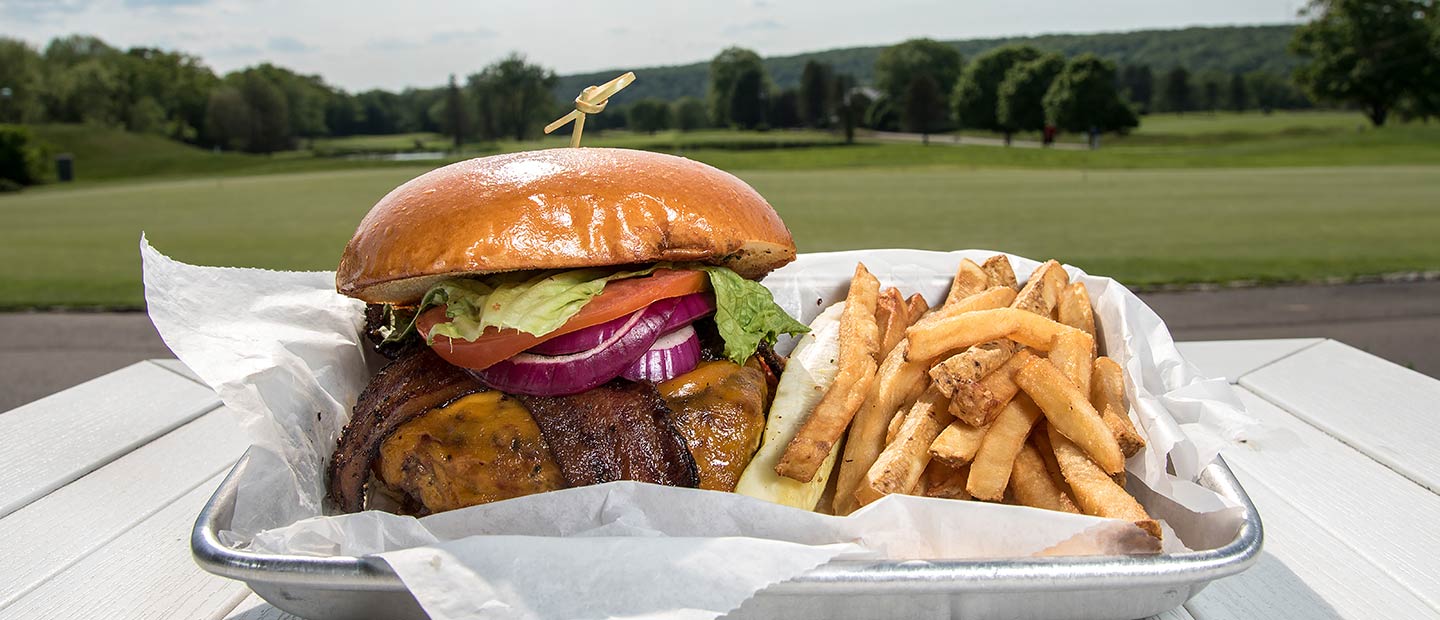 Hamburger and Fries with golf course in background