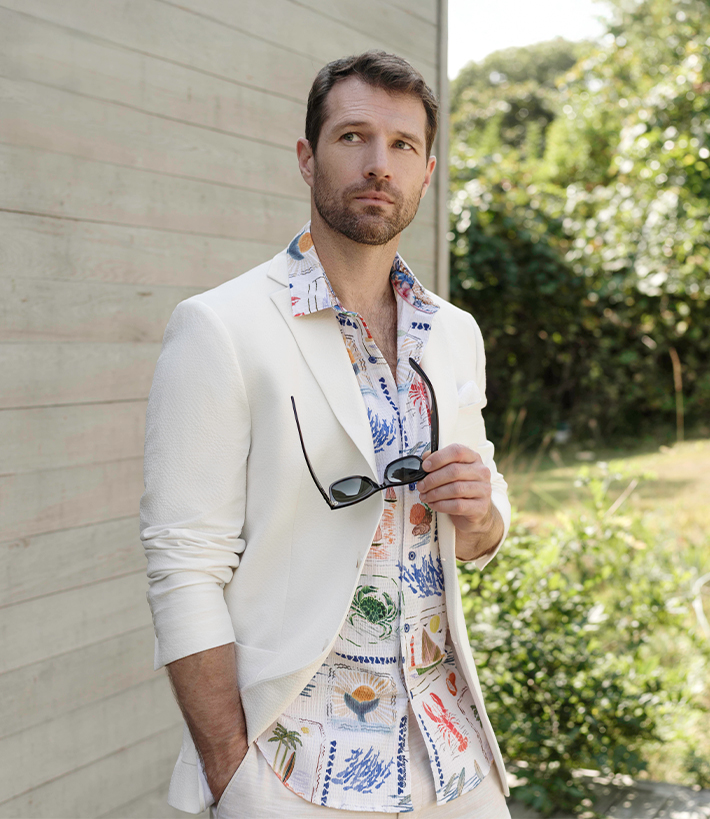 Robert Graham man in white blazer and nautical themed shirt underneath 