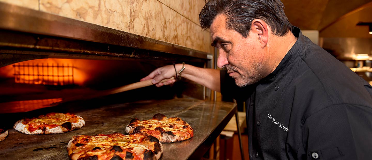 Todd English cooks pizza