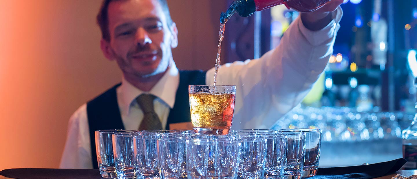 Bartender pouring a drink at a festival