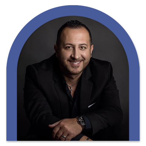 Photo of Tony Riccio holding a microphone
